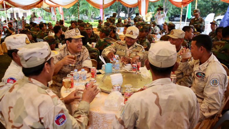 Cambodian Navy officials drink beer as they enjoy a lunch break after a closed-door meeting with Prime Minister Hun Sen yesterday in Stung Treng province. Facebook
